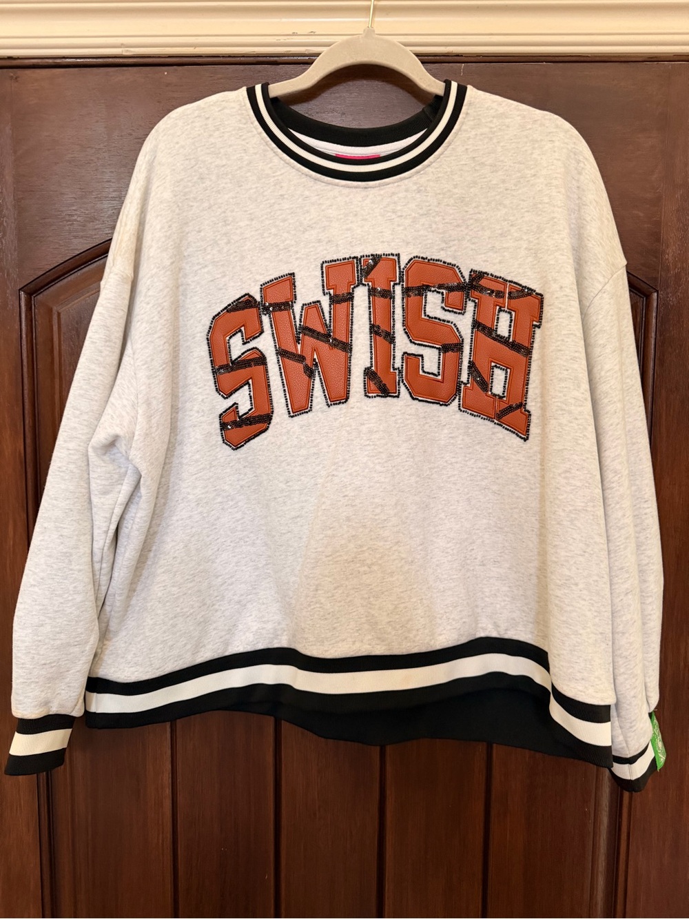 QUEEN OF SPARKLES Cream Crewneck Sweater with Orange SWISH Applique